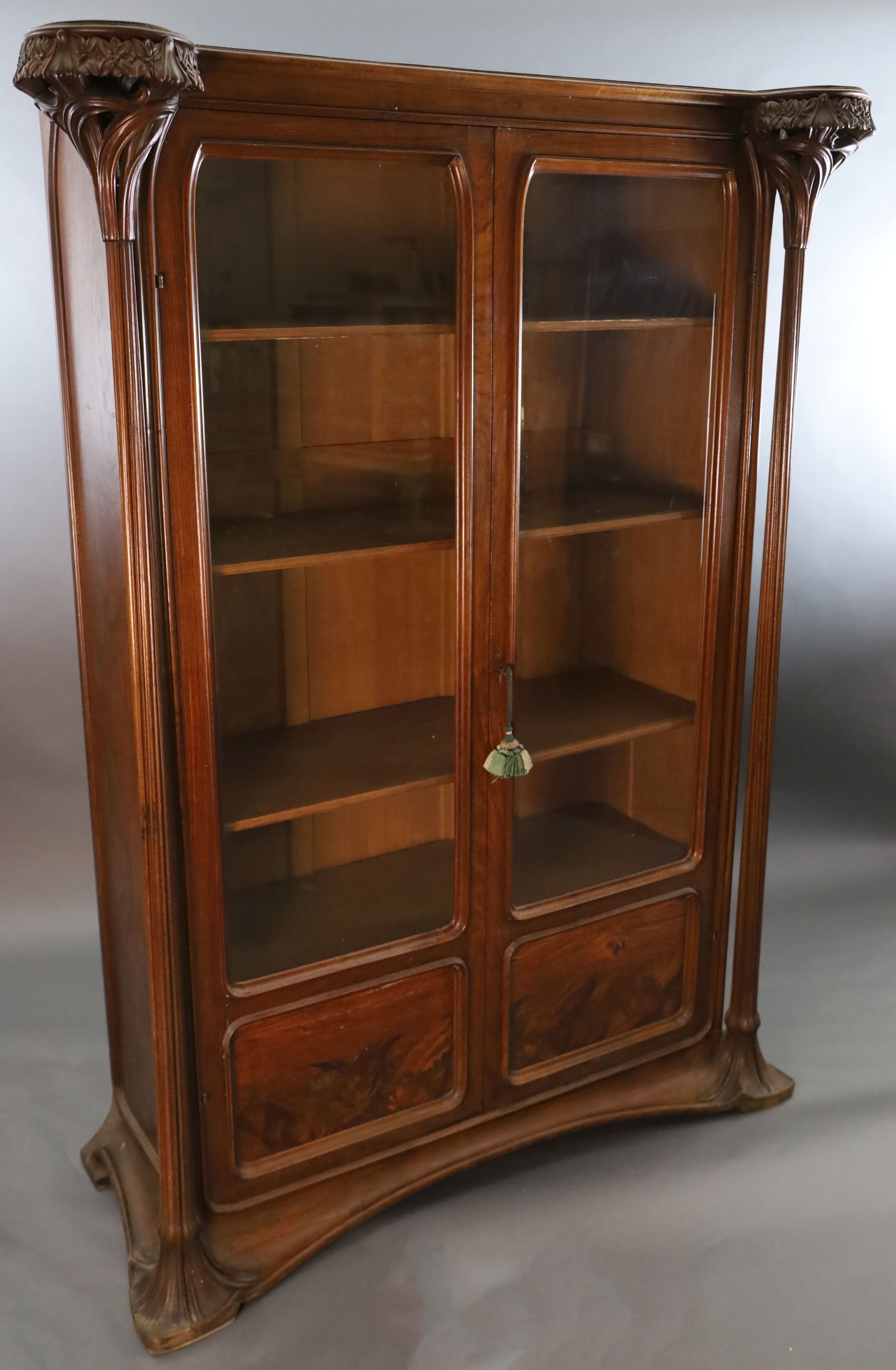 An Art Nouveau walnut and marquetry vitrine by Majorelle, W.5ft D.1ft 10in. H.6ft 7in.